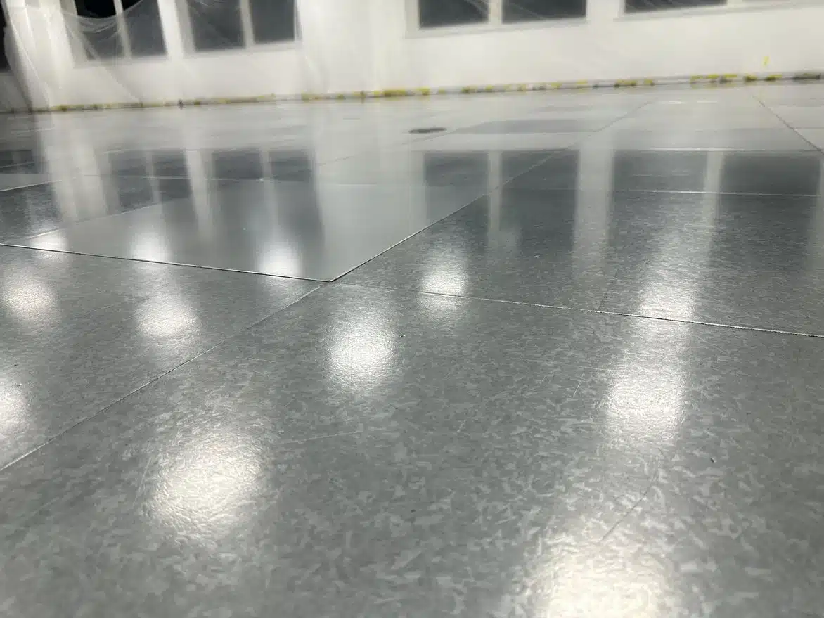 Raised access floor panels professionally restored with a smooth, clean surface finish after adhesive removal