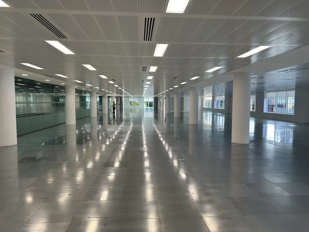 Finished raised floor in commercial setting after full adhesive removal and panel refurbishment
