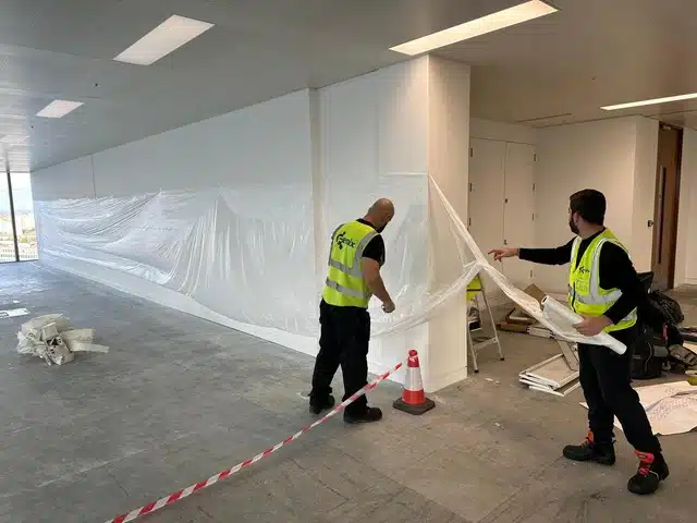 Walls and office fixtures fully shielded to prevent dust and damage during floor restoration